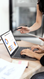 Businesswoman advisor, two business people talking, planning analyze investment and marketing on laptop in office.